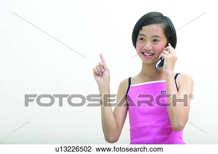 Stock Image - Cheerful, Asian Ethnicity, Casual Clothing, Body Language, Black Hair, Child, 12-13 Years. Fotosearch