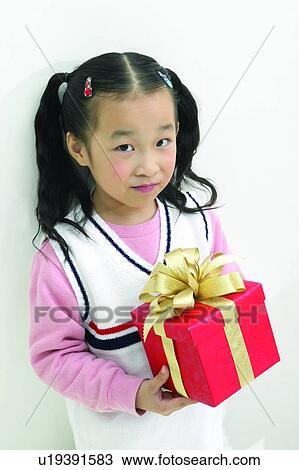 Stock Image - Child, Asian Ethnicity, Bow, Body Language, Black Hair, Close-Up, 6-7 Years. Fotosearch