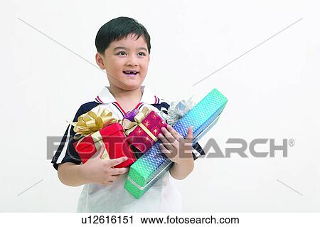 Happiness, Looking Away, Toothy Smile, Elementary Age, Holding, Polo Shirt View Large Photo Image Stock Image - Happiness, Looking Away, Toothy Smile, Elementary Age, Holding, Polo Shirt. Fotosearch