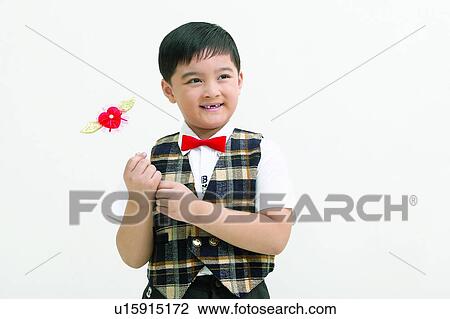 Holding, Cheerful, Bow Tie, Innocence, Elementary Age View Large Photo Image Stock Image - Holding, Cheerful, Bow Tie, Innocence, Elementary Age. Fotosearch
