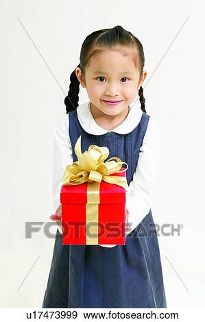 Stock Photo - Kids, Casual Clothing, Gift, Holding, Elementary Age. Fotosearch