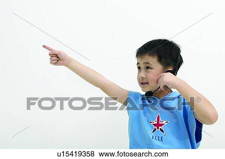 Pointing, Asian Ethnicity, T-Shirt, Body Language, White Background, Waist-Up, Elementary Age View Large Photo Image Stock Photo - Pointing, Asian Ethnicity, T-Shirt, Body Language, White Background, Waist-Up, Elementary Age. Fotosearch