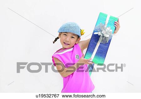 Stock Photo - Wrapped, One Girl Only, Indoor, Asian Ethnicity, Close-Up, Kids Body Language. Fotosearch