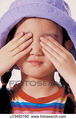 Stock Image - background, childhood, eyes, hands on eyes, clipping path, child, asian ethnicity. Fotosearch