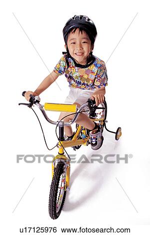 Stock Photograph - childhood, looking at camera, happiness, cycling helmet, boy. Fotosearch