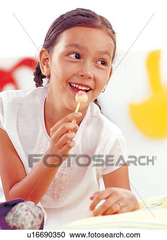 Stock Image - brown hair, braid, candy, carefree. Fotosearch
