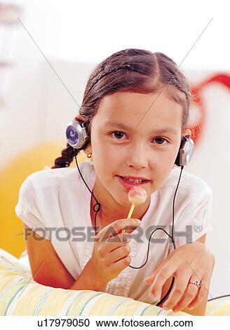 Stock Image - brown hair, braid, candy, carefree. Fotosearch