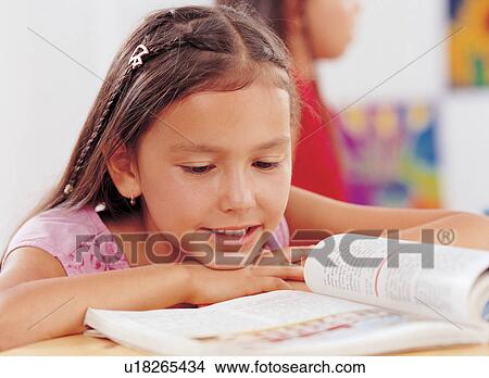 Picture - only children, desk, child, innocence, brown hair. Fotosearch