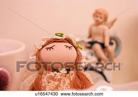 Stock Image - Cherub, Close-Up, Colored Background, Doll, Figurine. Fotosearch