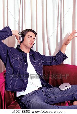 Stock Image - brown hair, casual clothing, cd player. Fotosearch