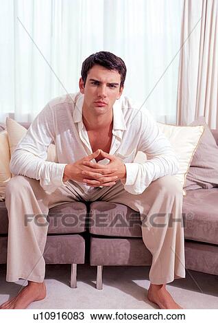 Stock Image - lifestyle, indoor, home interior, casual clothing, couch, curtain. Fotosearch