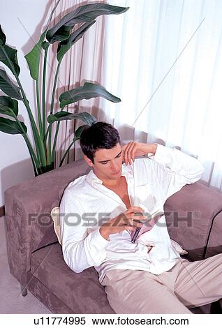 shadow, couch, young man, model, plant, lifestyle View Large Photo Image Stock Photography - shadow, couch, young man, model, plant, lifestyle. Fotosearch