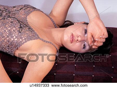 Stock Image - style, painted nails, posing, straight hair, dress. Fotosearch