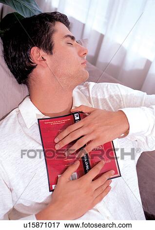 Stock Photo - young man, one person, waist up, literature, shadow, lifestyle. Fotosearch