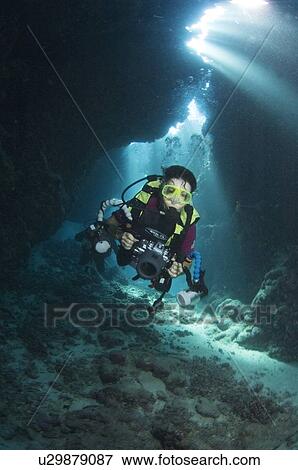 Diver in cave. St Johns, Egyptian Red Sea, light rays. 30-9-07 View Large Photo Image Stock Photo - Diver in cave. St Johns, Egyptian Red Sea, light rays. 30-9-07. Fotosearch