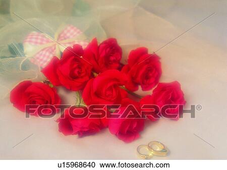 Stock Image - gold, wedding, ring, flower, heart shaped, love, bow. Fotosearch