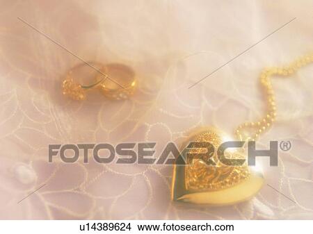Picture - heart shaped, gold, carve, necklace, ring, fabric. Fotosearch