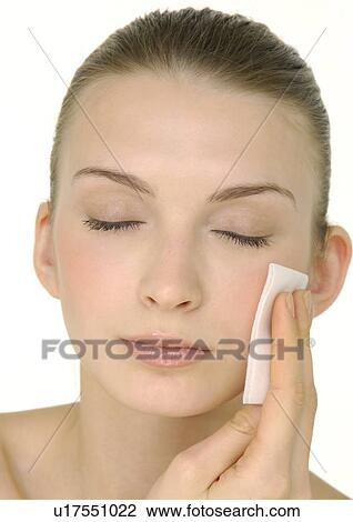 Close-up of a young woman applying face powder View Large Photo Image Stock Image - Close-up of a young woman applying face powder. Fotosearch