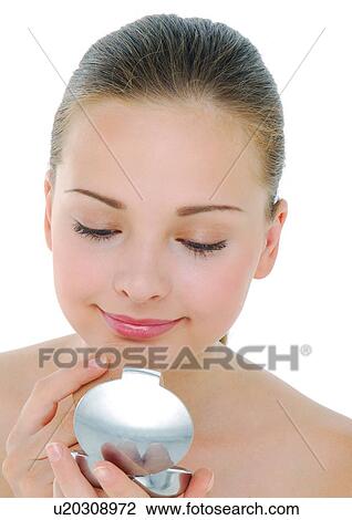 Close-up of a young woman applying face powder View Large Photo Image Stock Image - Close-up of a young woman applying face powder. Fotosearch