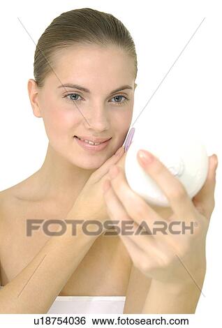 Young woman applying face powder View Large Photo Image Stock Photograph - Young woman applying face powder. Fotosearch