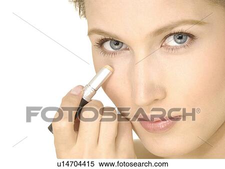 Portrait of a young woman applying concealing stick on her face View Large Photo Image Stock Photography - Portrait of a young woman applying concealing stick on her face. Fotosearch