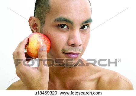 Stock Image - Asian Ethnicity, Expressions, Close-Up, Apple. Fotosearch