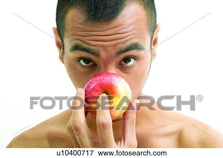Stock Photo - Asian Ethnicity, Expressions, Close-Up, Apple. Fotosearch