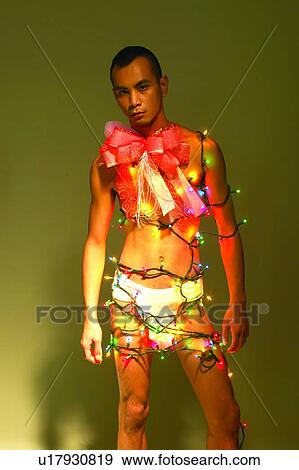 Stock Photo - Bare Chest, Electric Light, Christmas Lights, Asian Ethnicity. Fotosearch