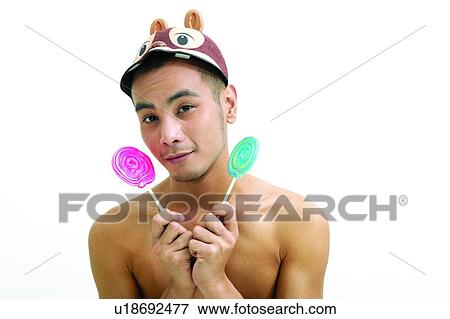 Holding, Asian Ethnicity, Head And Shoulders, Lollipop, Men Expressions, Posing View Large Photo Image Stock Photo - Holding, Asian Ethnicity, Head And Shoulders, Lollipop, Men Expressions, Posing. Fotosearch