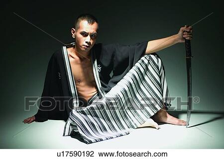 Stock Image - Serious, Portrait, Holding, Asian Ethnicity, Sword. Fotosearch
