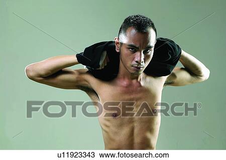 Stock Image - Waist-Up, Young Adult, Expressions, Taking Off, Serious, Shaved Head. Fotosearch