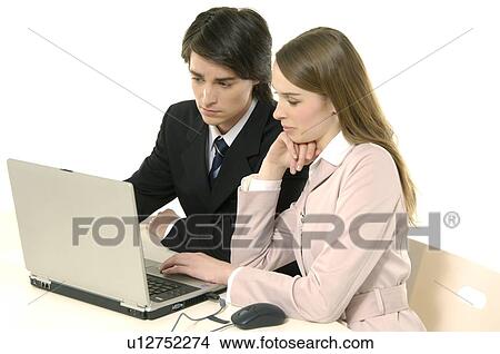 Businessman and a businesswoman working on a laptop View Large Photo Image Picture - Businessman and a businesswoman working on a laptop. Fotosearch