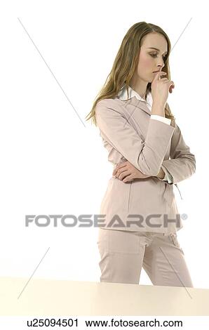 Businesswoman standing with her hand on her chin View Large Photo Image Stock Image - Businesswoman standing with her hand on her chin. Fotosearch