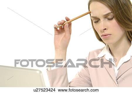 Picture - Close-up of a businesswoman thinking in front of a laptop with her eyes closed. Fotosearch