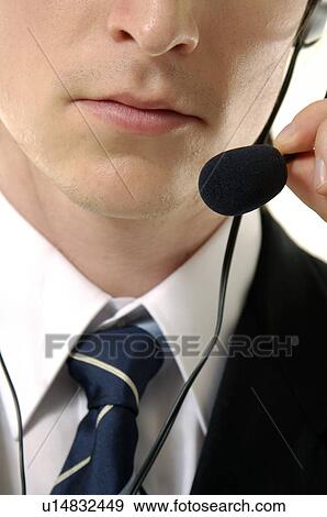 Close-up of a male customer service representative talking on a headset View Large Photo Image Stock Photo - Close-up of a male customer service representative talking on a headset. Fotosearch
