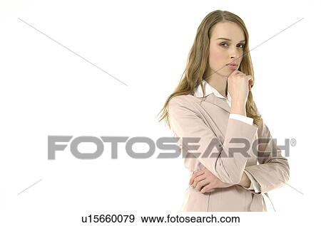 Portrait of a businesswoman standing with her hand on her chin and looking serious View Large Photo Image Stock Photo - Portrait of a businesswoman standing with her hand on her chin and looking serious. Fotosearch