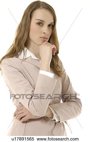 Portrait of a businesswoman standing with her hand on her chin and looking serious View Large Photo Image Stock Photography - Portrait of a businesswoman standing with her hand on her chin and looking serious. Fotosearch