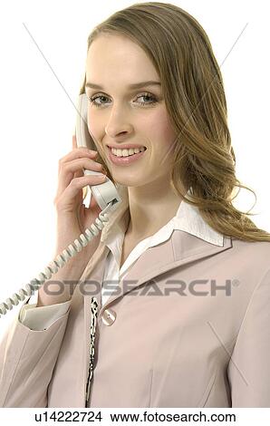 Picture - Portrait of a businesswoman talking on the telephone and smiling. Fotosearch