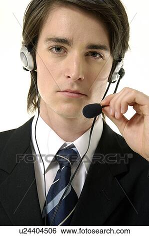 Stock Photograph - Portrait of a male customer service representative talking on a headset. Fotosearch