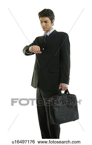 Businessman checking the time in his wristwatch View Large Photo Image Stock Photograph - Businessman checking the time in his wristwatch. Fotosearch