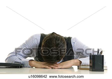 Businessman napping on a desk in an office View Large Photo Image Stock Image - Businessman napping on a desk in an office. Fotosearch
