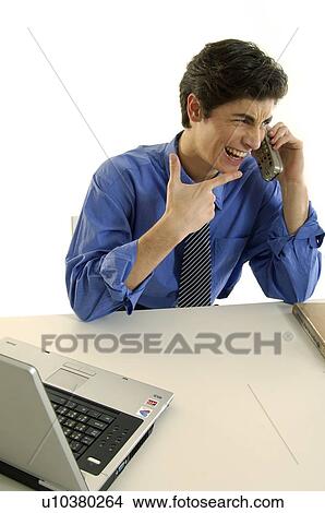 Picture - Businessman talking on a cordless phone and smiling. Fotosearch