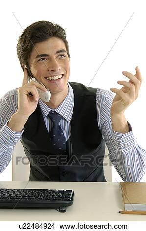 Businessman talking on a mobile phone and smiling View Large Photo Image Picture - Businessman talking on a mobile phone and smiling. Fotosearch