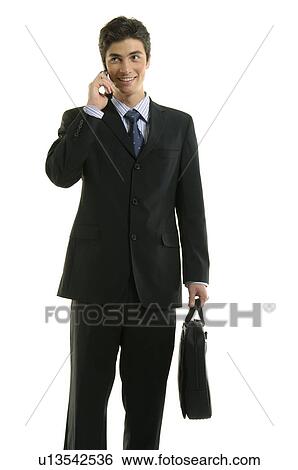 Businessman talking on a mobile phone and smiling View Large Photo Image Stock Photograph - Businessman talking on a mobile phone and smiling. Fotosearch