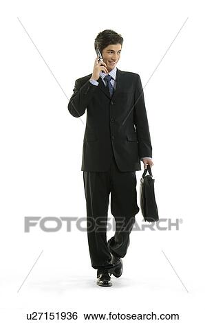 Stock Photograph - Businessman talking on a mobile phone and smiling. Fotosearch