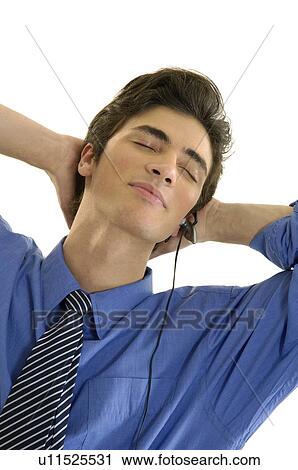 Close-up of a businessman listening to music and smiling with his eyes closed View Large Photo Image Stock Image - Close-up of a businessman listening to music and smiling with his eyes closed. Fotosearch