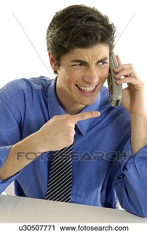 Stock Image - Close-up of a businessman talking on a cordless phone and smiling. Fotosearch