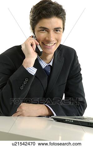 Portrait of a businessman talking on a mobile phone and smiling View Large Photo Image Stock Image - Portrait of a businessman talking on a mobile phone and smiling. Fotosearch