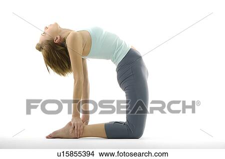 Picture - Side profile of a young woman practicing yoga. Fotosearch