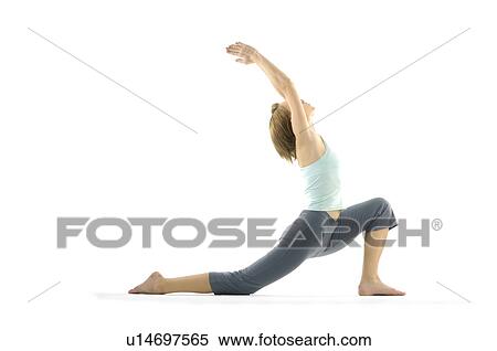 Stock Photography - Side profile of a young woman practicing yoga. Fotosearch